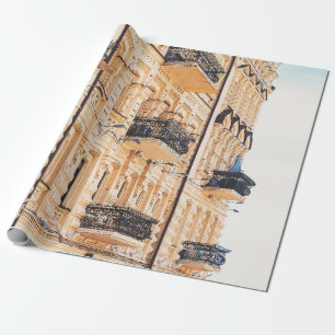 An old yellow house with wrought-iron balconies. f wrapping paper
