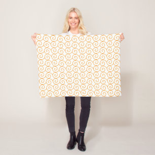 an orange and white background with swirls fleece blanket