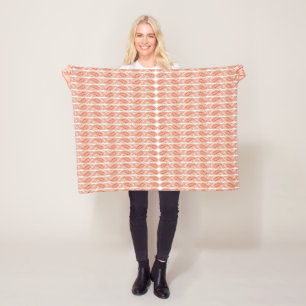 an orange and white pattern on a white background fleece blanket