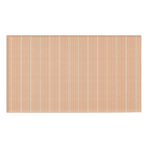 an orange and white striped background with small  name tag