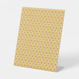 an orange and yellow background with circles pedestal sign