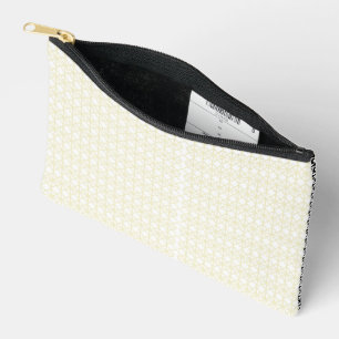an orange and yellow background with small dots accessory pouch