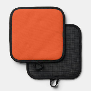 an orange background with a black border pot holder