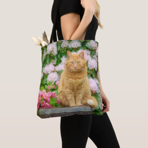 An Orange Cat in a Garden with Pink Spring Flowers Tote Bag