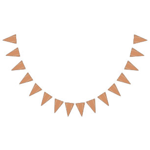 An orange rug with a textured pattern lies flat on bunting