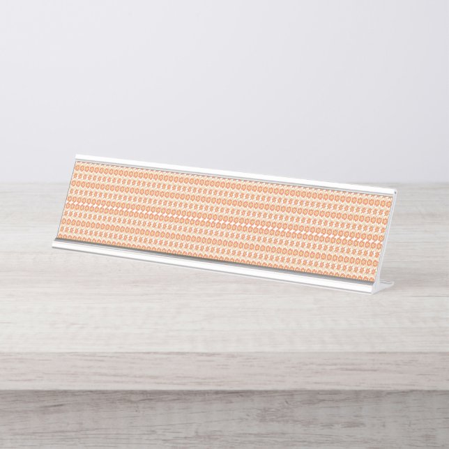 An orange rug with a textured pattern lies flat on desk name plate (Front)