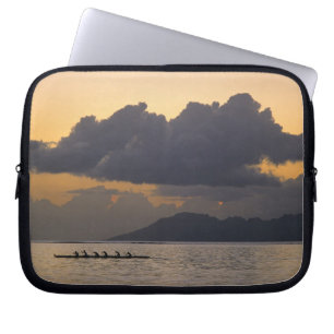 An outrigger canoe team practices off the coast laptop sleeve