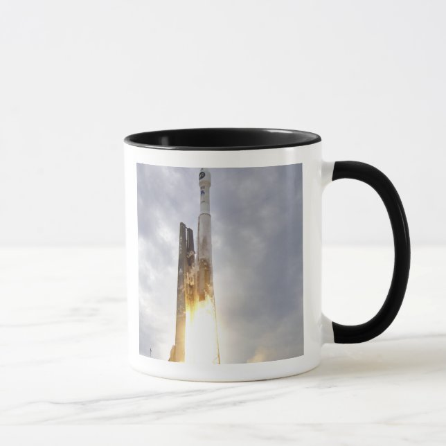 An United Launch Alliance Atlas V rocket lifts Mug (Right)