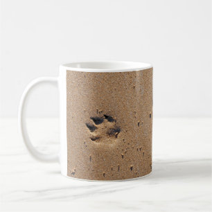 Animal paw prints in sand coffee mug