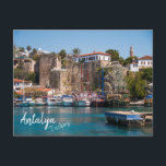 Antalya, Turkey: Old City Marina Postcard<br><div class="desc">The Old City Marina in Antalya is one of the most visited areas of the resort city.  In the background of the photograph,  the Seljuk Minaret can be seen standing over the rocky cliffs that surround the harbour,  filled with tourist boats.  This Antalya postcard is fully customisable.</div>