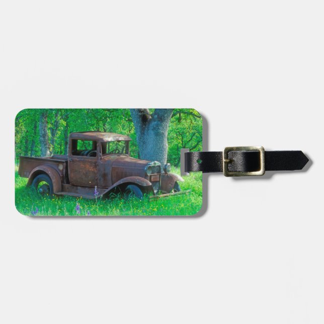 Antique rusted truck in a meadow luggage tag (Front Horizontal)