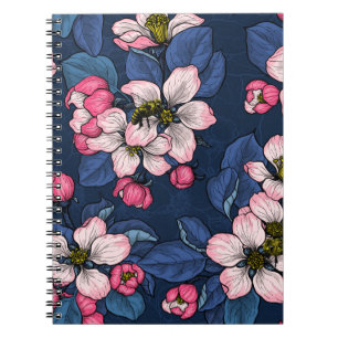 Apple blossom on a dark blue notebook