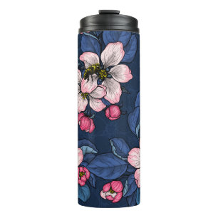 Apple blossom on a dark blue thermal tumbler