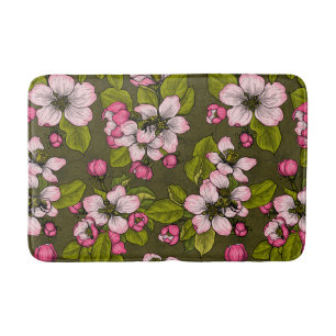 Apple blossom on dark green bath mat