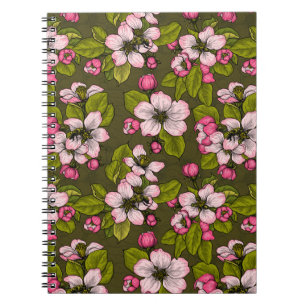 Apple blossom on dark green notebook