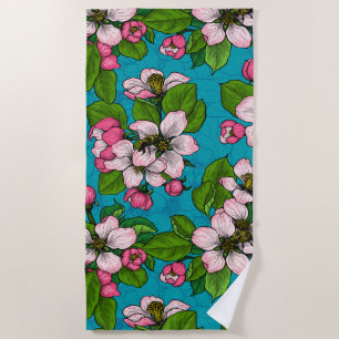 Apple blossom on turquoise beach towel