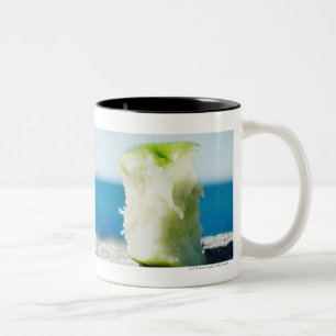 Apple core in the dirt Two-Tone coffee mug