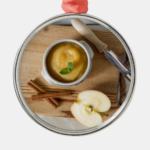 Applesauce with cinnamon in stoneware bowl metal tree decoration