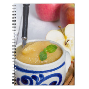 Applesauce with cinnamon in stoneware bowl notebook