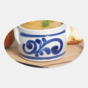 Applesauce with cinnamon in stoneware bowl oval sticker