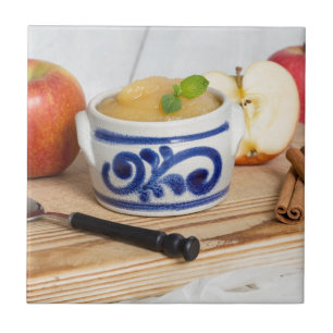 Applesauce with cinnamon in stoneware bowl tile