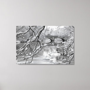 Arch Bridge over Frozen River in Winter Canvas Print