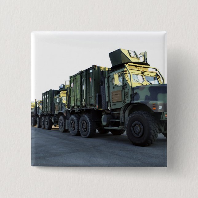 Armoured trucks sit on the pier at Morehead City 15 Cm Square Badge (Front)