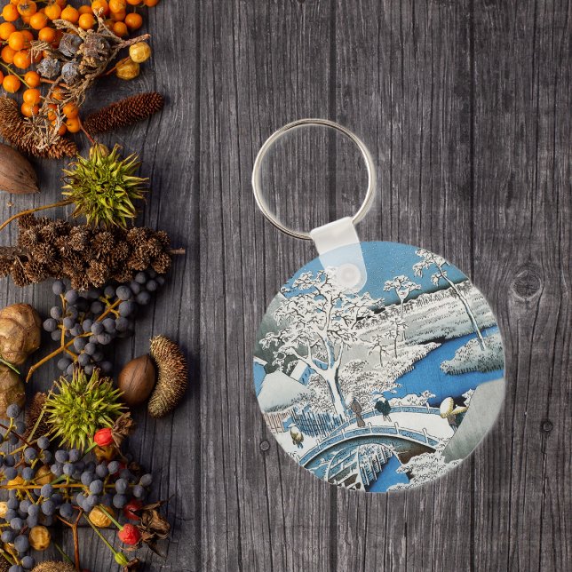 Asian Bridge and Snow Landscape Keychain (Asian winter scene people on snow covered bridge over vibrant blue water on keychain.)