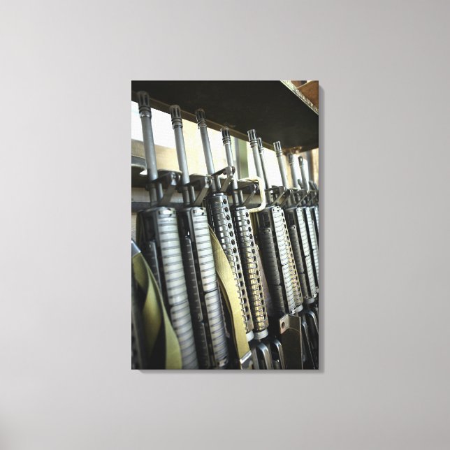 Assault rifles stand ready on the weapons rack canvas print (Front)