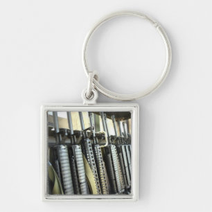 Assault rifles stand ready on the weapons rack key ring
