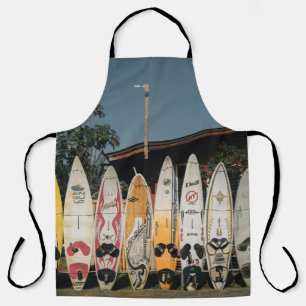 Assorted surfing boards stands on open field in th apron