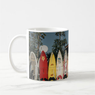 Assorted surfing boards stands on open field in th coffee mug