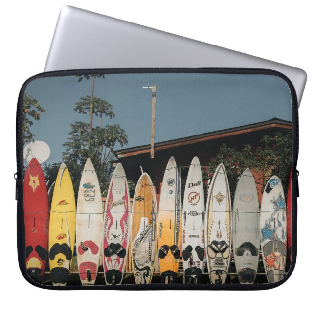 Assorted surfing boards stands on open field in th laptop sleeve (Front)