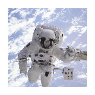 Astronaut Above Earth During Spacewalk Canvas Print