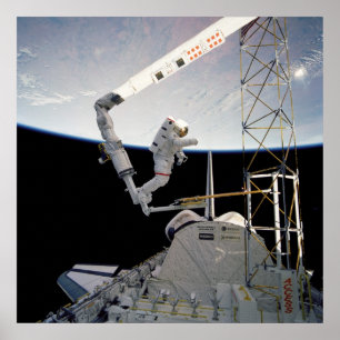 Astronaut working aboard Space Shuttle Atlantis Poster