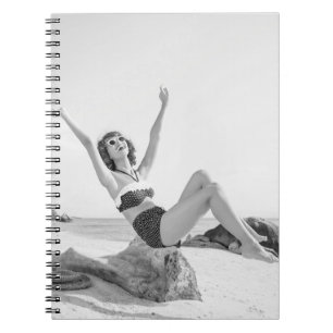 Attractive young woman in bikini on the beachvinta notebook