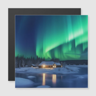 Aurora borealis over winter cabin