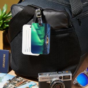 Aurora borealis over winter cabin luggage tag
