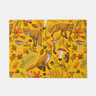 Autumn foxes on orange doormat