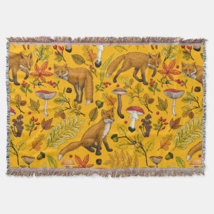 Autumn foxes on orange throw blanket