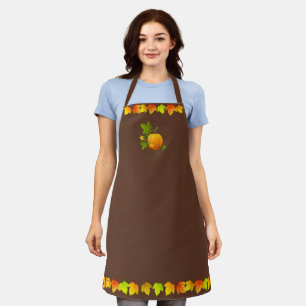 Autumn leaves and pumpkin on brown apron