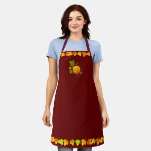 Autumn leaves and pumpkin on maroon apron
