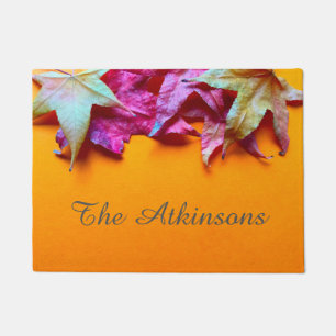 Autumn leaves on orange background doormat