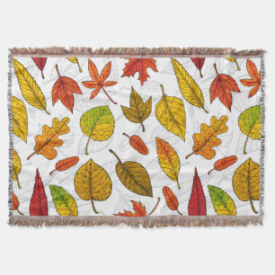 Autumn leaves on white throw blanket