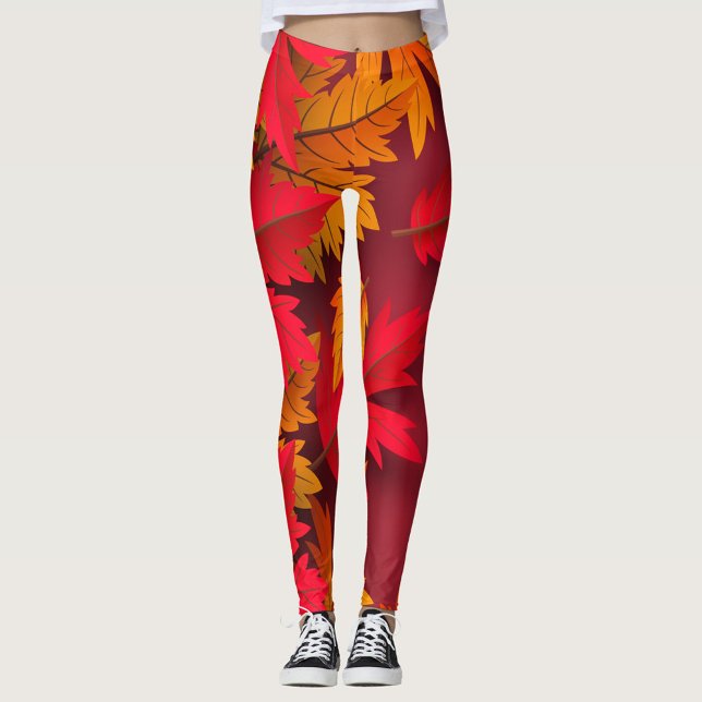 Autumn Leggings ( A model showcases vibrant leggings adorned with autumn leaves in shades of red and orange. )