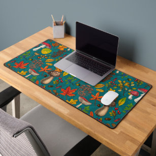 Autumn mushrooms, leaves, nuts and berries on blue desk mat