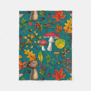 Autumn mushrooms, leaves, nuts and berries on blue fleece blanket
