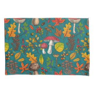 Autumn mushrooms, leaves, nuts and berries on blue pillowcase