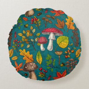 Autumn mushrooms, leaves, nuts and berries on blue round cushion