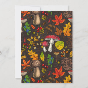 Autumn mushrooms, leaves, nuts and berries on dark